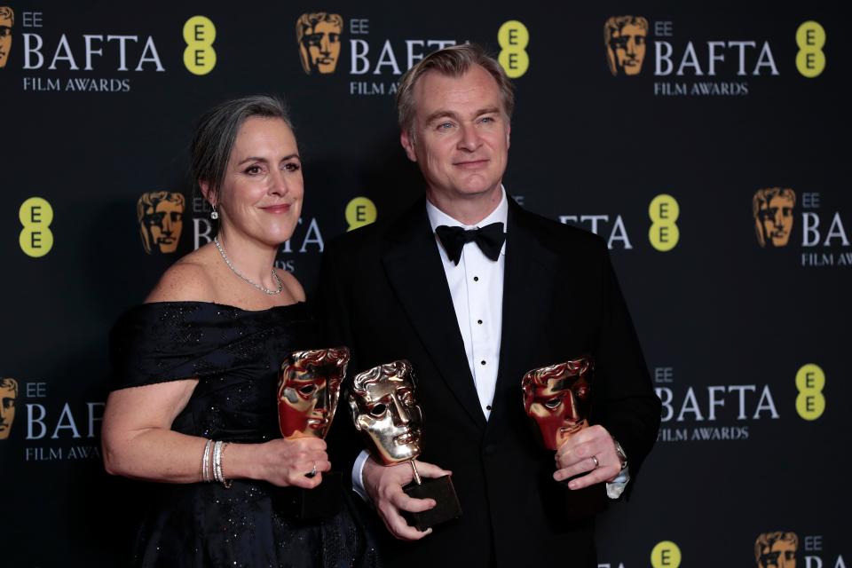 Emma Thomas and Christopher Nolan pose with the best film award for "Oppenheimer."