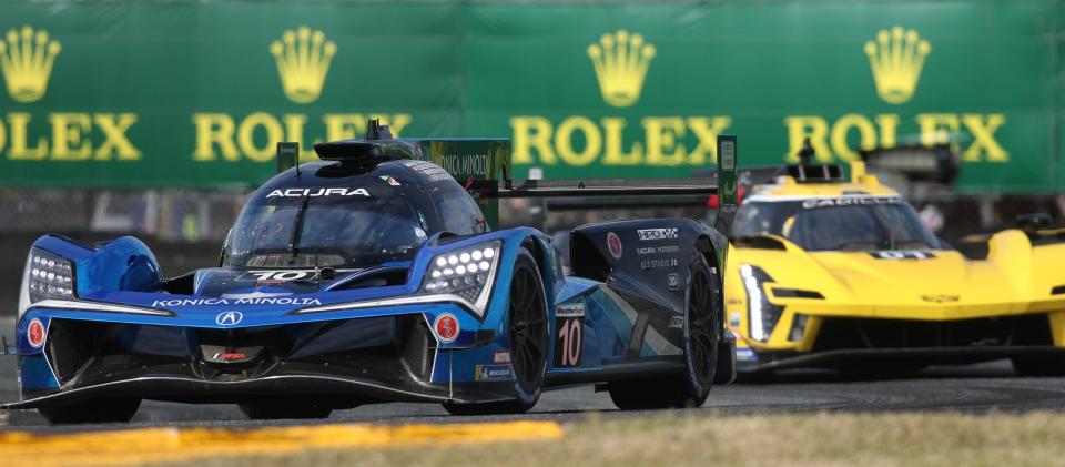 The no. 10 Acura ARX-06 works the eaast horseshoe ahead of the no. 01 Cadillac, Saturday January 28, 2023 in the early hours of the Rolex 24 at Daytona International Speedway.