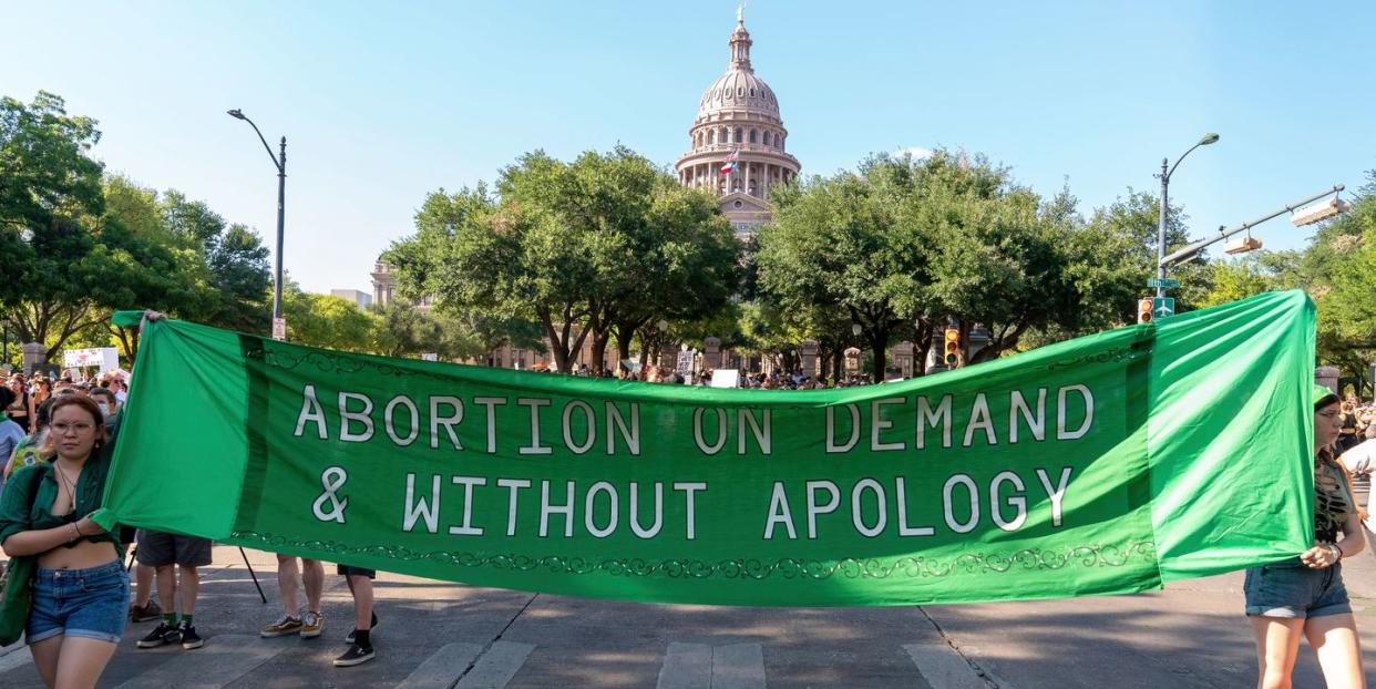 a protest banner that reads abortion on demand and without apology
