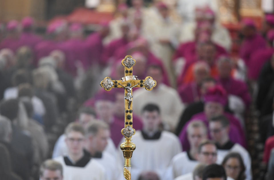 Bishops and altar boys arrive for the opening mass of the German bishops' conference in Fulda, Germany, Tuesday, Sept. 25, 2018 where the bishops will discuss a study on sexual abuse in the Catholic church in Germany. (Arne Dedert/dpa via AP)