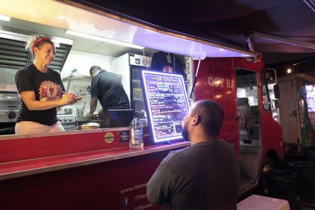 A man orders food at a food truck in San Juan, Puerto Rico, November 3, 2016. REUTERS/Alvin Baez