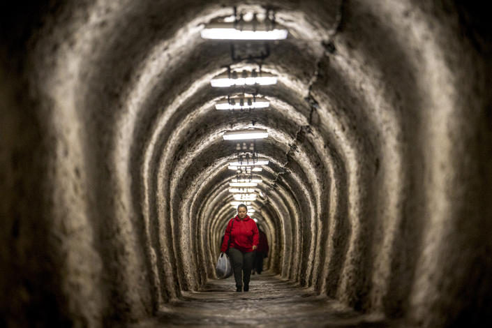A woman walks inside an access gallery of the Salina Turda, a former salt mine turned touristic attraction, now listed by emergency authorities as a potential civil defense shelter in Turda, central Romania, Monday, Oct. 17, 2022. Fighting around Ukraine's nuclear power plants and Russia's threats to use nuclear weapons have reawakened nuclear fears in Europe. This is especially felt in countries near Ukraine, like Poland, where the government this month ordered an inventory of the country's shelters as a precaution. (AP Photo/Vadim Ghirda)