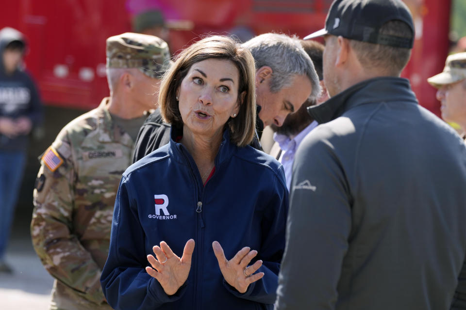 Iowa Gov. Kim Reynolds speaks with a worker at a command station after touring tornado damage, Wednesday, May 22, 2024, in Greenfield, Iowa. (AP Photo/Charlie Neibergall)