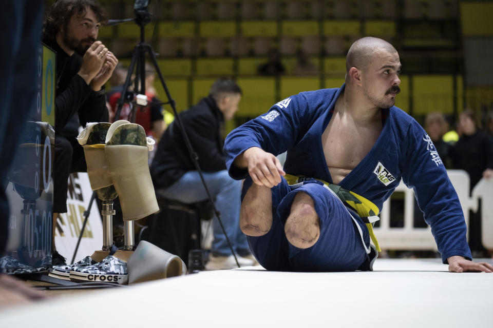 26-year-old Vasyl Oksyntiuk, Ukrainian war veteran prepares to compete at the Ukrainian national competition of jiu jitsu in Kyiv, Ukraine, Sunday, Oct. 29, 2023. More than 20,000 people in the Ukraine have lost limbs from injuries since the start of the Russian war, many of them soldiers. Some of them have learned to deal with their psychological trauma by practicing a form of Brazilian jiu-jitsu. (AP Photo/Roman Hrytsyna)