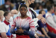 Simone Biles, of the United States, looks at the score after her performance on the balance beam during the artistic gymnastics women's apparatus final at the 2020 Summer Olympics, Tuesday, Aug. 3, 2021, in Tokyo, Japan. (AP Photo/Natacha Pisarenko)