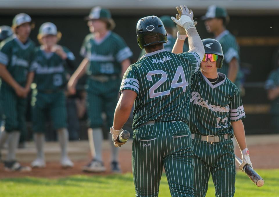 Richwoods' Ben Waller (13) high-fives teammate Alex Kilgore after he scored the eventual game-winning run over Streator in the seventh inning of their Class 3A baseball sectional semifinal Wednesday, May 31, 2023 in Metamora. The Knights rallied to defeat the Bulldogs 5-4.
