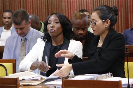 Jamaica's Olympic sprinter Sherone Simpson (front L), who tested positive for doping at the Jamaican Championships in 2013, sits with her attorney Dianne Chai (front R) as they wait for the beginning of the hearing before the country's anti-doping commission in Kingston January 7, 2014. REUTERS/Gilbert Bellamy