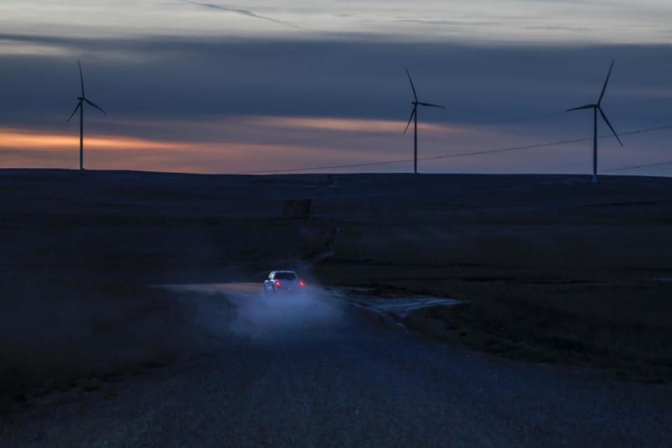 Turbines spin at sundown at NextEra Energy's Clearwater wind farm, which sends power from Montana to Oregon and Washington.