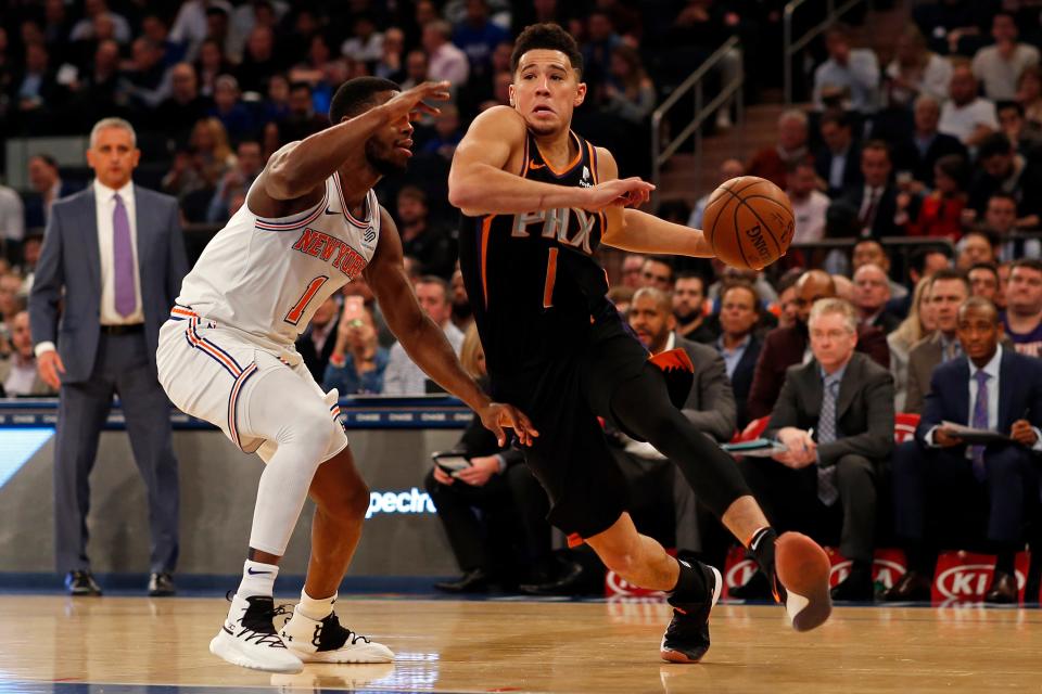 Dec 17, 2018; New York, NY, USA; Phoenix Suns guard Devin Booker (1) drives to the baskrt past New York Knicks guard Emmanuel Mudiay (1) during the first half at Madison Square Garden. Mandatory Credit: Adam Hunger-USA TODAY Sports