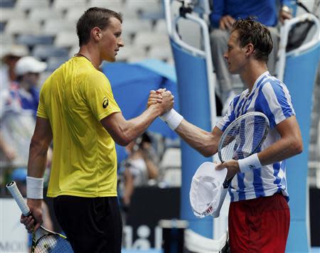 Tomas Berdych (R) of the Czech Republic shakes hands with Kenny De Schepper of France after winning their men's singles match at the Australian Open 2014 tennis tournament in Melbourne January 15, 2014. REUTERS/Bobby Yip