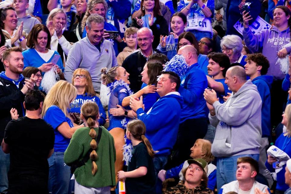 Raena Worley celebrates with her family in the stands after earning a perfect score for her floor routine during Kentucky’s Excite Night meet against Georgia at Rupp Arena.