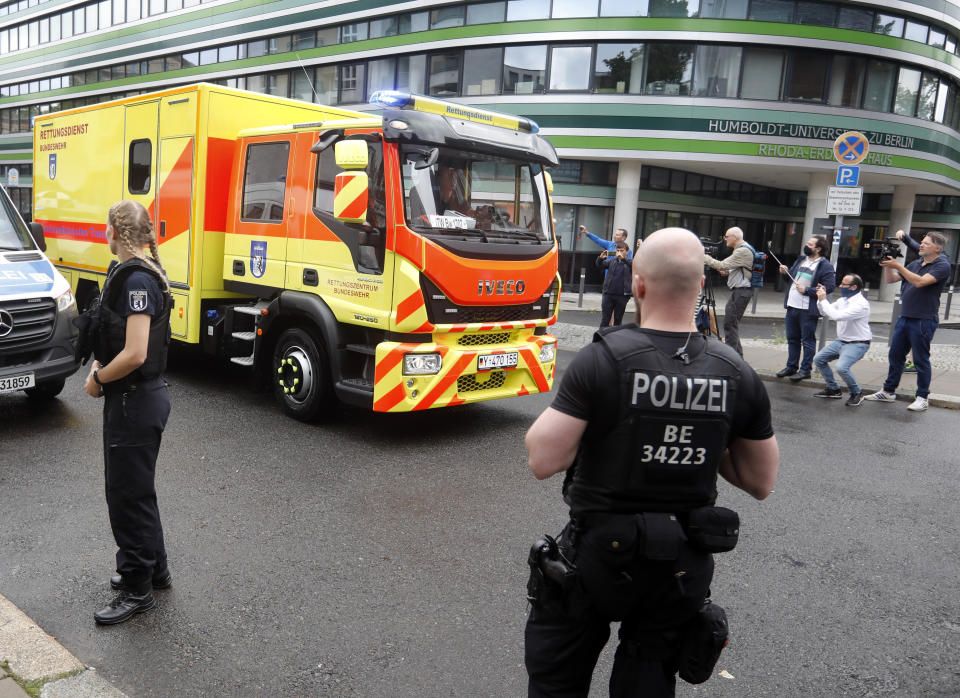 -FILE- In this Saturday, Aug. 22, 2020, file image, an ambulance which is believed to transport Alexei Navalny arrives at the Charite hospital in Berlin, Germany. Russia came under renewed pressure to explain the nerve agent attack on opposition figure Alexei Navalny as the annual meeting of the global chemical weapons watchdog got underway in The Hague, Netherlands, Monday Nov. 30, 2020, amid measures aimed at reining in the spread of the coronavirus. (AP Photo/Markus Schreiber, File)