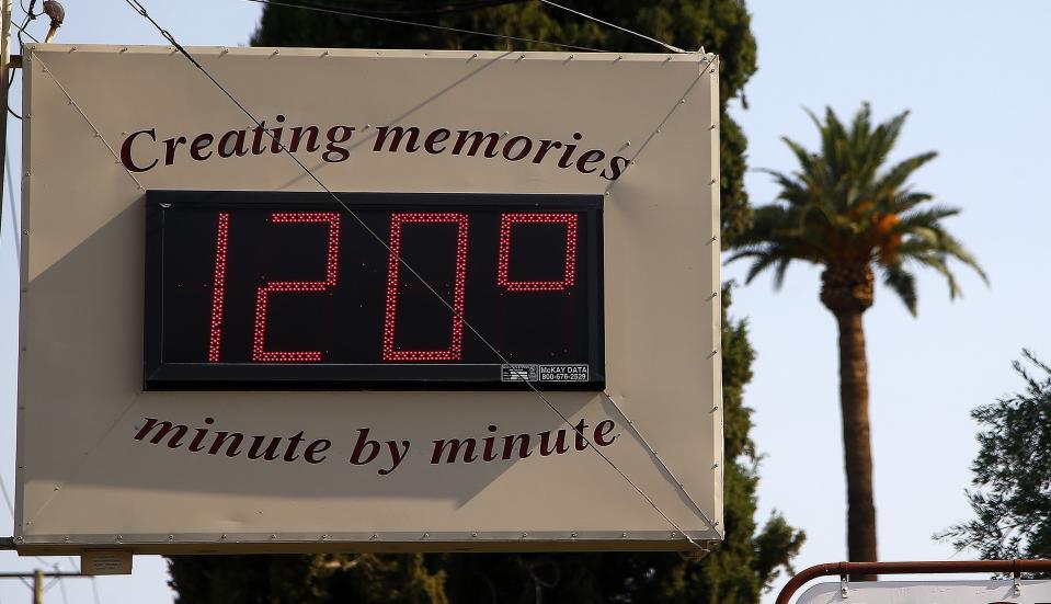 FLE - In this June 20, 2017 file photo, a local temperature sign reads 120-degrees Fahrenheit as temperatures climb to near-record highs in Phoenix. Scientists say climate change is faster, more extensive and worse than they thought a quarter century ago. (AP Photo/Ross D. Franklin, File)