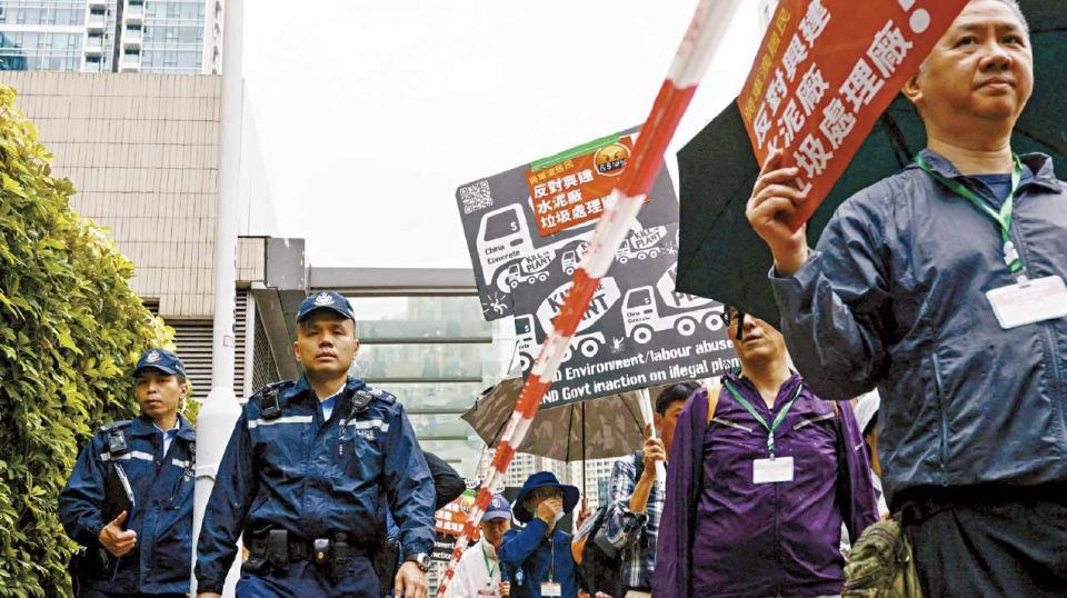 疫後首獲警批遊行 團體反對將軍澳填海 約 80 人頸掛號碼牌圍帶分隔稱無奈接受