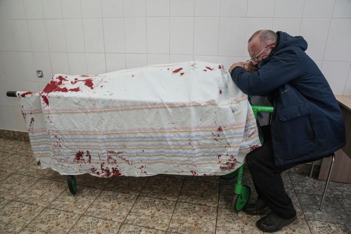 A father cries on his son&#39;s lifeless body lying on a stretcher at a maternity hospital converted into a medical ward in Mariupol, Ukraine, on March 2, 2022.