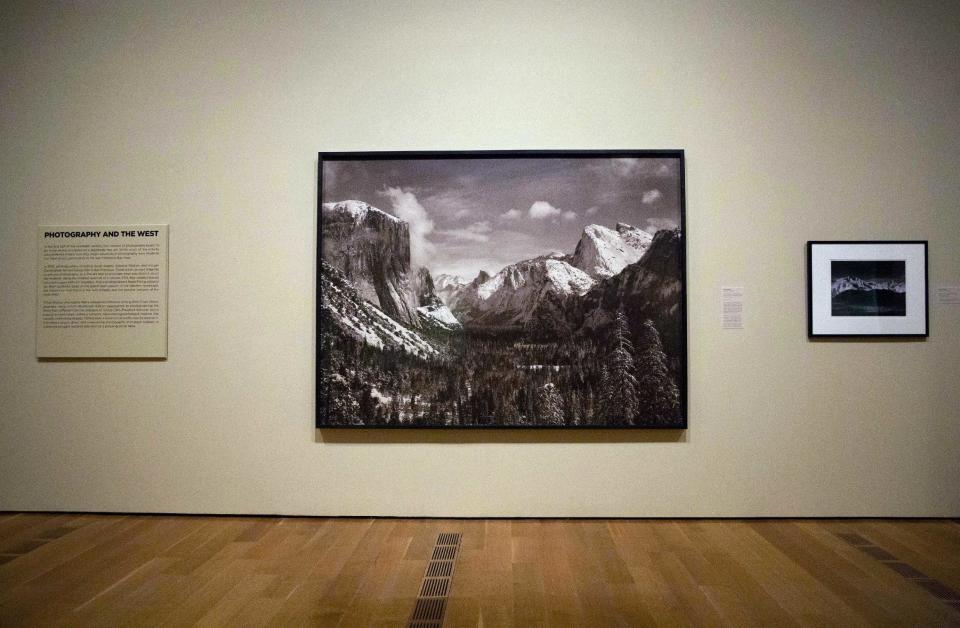In this Monday, Feb. 6, 2017 photo, Ansel Adams' 1940 photograph "Yosemite Valley from Inspiration Point, Winter, Yosemite National Park," is displayed in the exhibit "Cross Country: The Power of Place in American Art, 1915-1950," at the High Museum of Art in Atlanta. The new exhibition at takes a look at how American artists during the modernist period traveled outside cities to find inspiration in the rural landscape. (AP Photo/David Goldman)