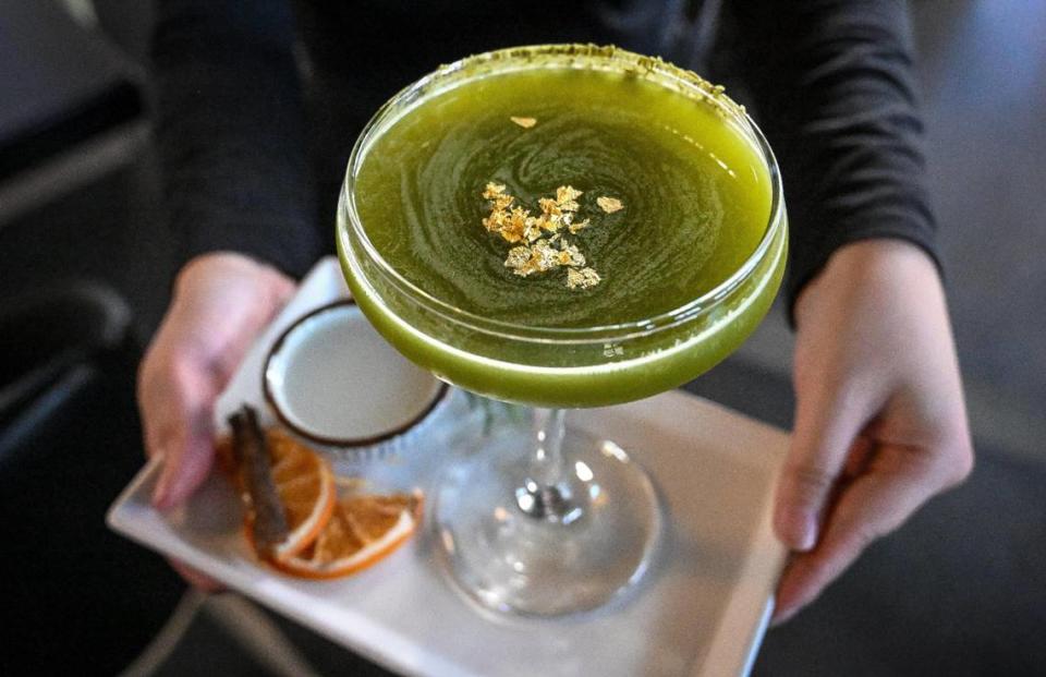 The gyokuru martini comes with jumai sake, blue agave, lime juice, matcha, gold flakes along side a shot of nigori sake at O-iza Japanese Cuisine in the River Park shopping center. CRAIG KOHLRUSS/ckohlruss@fresnobee.com