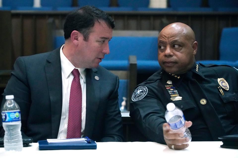 Mississippi Public Safety Commissioner Sean Tindell, left, confers with Jackson Police Chief James Davis during a town hall meeting to address youth crime issues in Jackson, Miss., Feb. 14, 2023.