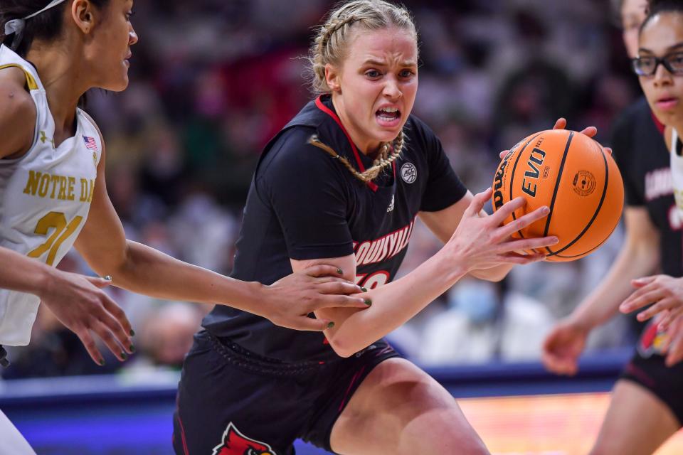 Feb 27, 2022; South Bend, Indiana, USA; Louisville Cardinals guard Hailey Van Lith (10) drives to the basket as Notre Dame Fighting Irish guard Anaya Peoples (21) defends in the first half at the Purcell Pavilion. Mandatory Credit: Matt Cashore-USA TODAY Sports