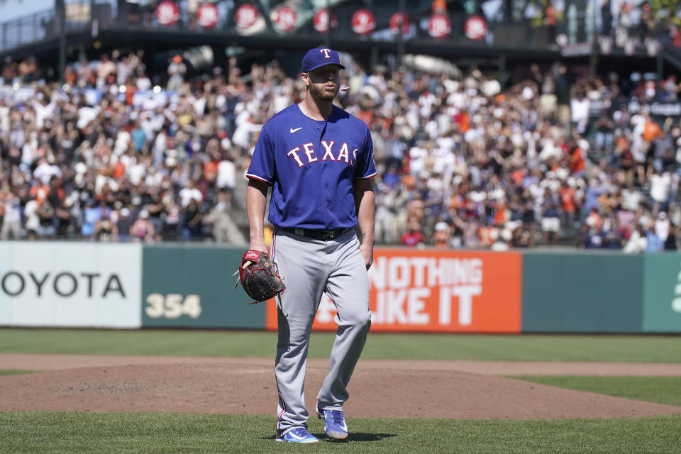 Texas Rangers pitcher Will Smith walks off the mound after allowing a two-run home run to San Francisco Giants' Patrick Bailey during the tenth inning of a baseball game in San Francisco, Sunday, Aug. 13, 2023. (AP Photo/Jeff Chiu)