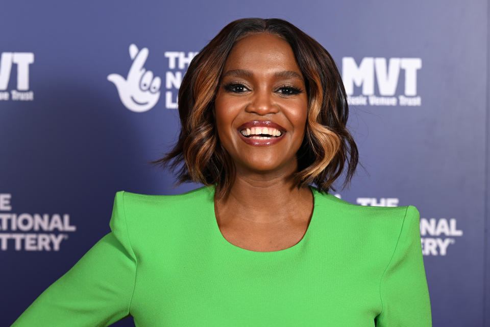 Oti Mabuse smiling and wearing a green dress