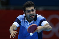 "Taxiiiii!" <br>LONDON, ENGLAND - JULY 29: Noshad Alamiyan of Iran plays a backhand in his Men's Singles Table Tennis second round match against Peng Tang of Hong Kong on Day 2 of the London 2012 Olympic Games at ExCeL on July 29, 2012 in London, England. (Photo by Feng Li/Getty Images)