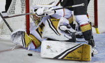 Vegas Golden Knights goalie Logan Thompson scrambles to block the net during third-period NHL hockey game action against the Calgary Flames in Calgary, Albera, Thursday, March 23, 2023. (Jeff McIntosh/The Canadian Press via AP)