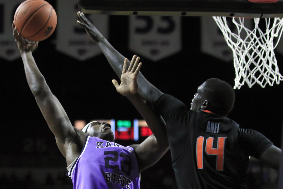 Kansas State forward Austin Trice (23) shoots over Oklahoma State forward Yor Anei (14) during the second half of an NCAA college basketball game in Manhattan, Kan., Saturday, Feb. 23, 2019. (AP Photo/Orlin Wagner)