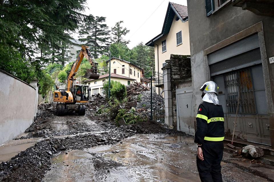 A fireman inspects damages caused by a landslide in Laglio, on July 28, 2021, after heavy rain caused floods in towns surrounding Lake Como in northern Italy.