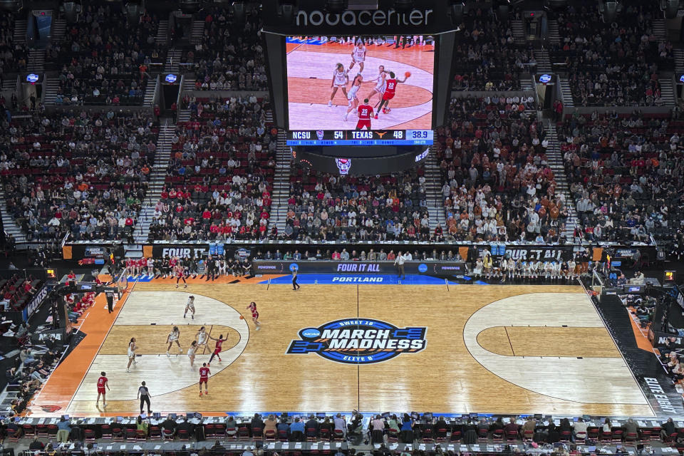 Texas players defend as North Carolina State players pass the ball during the second half of an Elite Eight college basketball game in the women's NCAA Tournament, Sunday, March 31, 2024, in Portland, Ore. North Carolina State won 76-66. (AP Photo/Tim Booth)