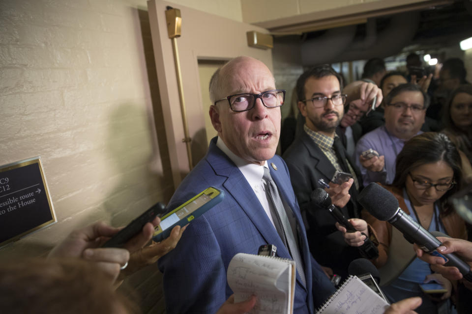 FILE - In this July 28, 2017, file photo, House Energy and Commerce Committee Chairman Rep. Greg Walden, R-Ore.,is surrounded by reporters on Capitol Hill in Washington. The congressman running for his 11th term in a vast district in rural Oregon took a dig at his Democratic rival, saying that her wife hails from a "distant branch" of a prominent ranching family that actually supports him. (AP Photo/J. Scott Applewhite, File)