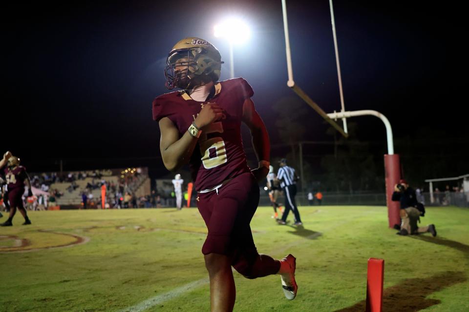 St. Augustine's Devonte Lyons (6) celebrates his touchdown score during the fourth quarter of an FHSAA Class 3S state semifinal high school football matchup Friday, Nov. 30, 2023 at St. Augustine High School in St. Augustine, Fla. The St. Augustine Yellow Jackets defeated the Dunbar Tigers 35-14 and advance to the state final in Tallahassee. [Corey Perrine/Florida Times-Union]