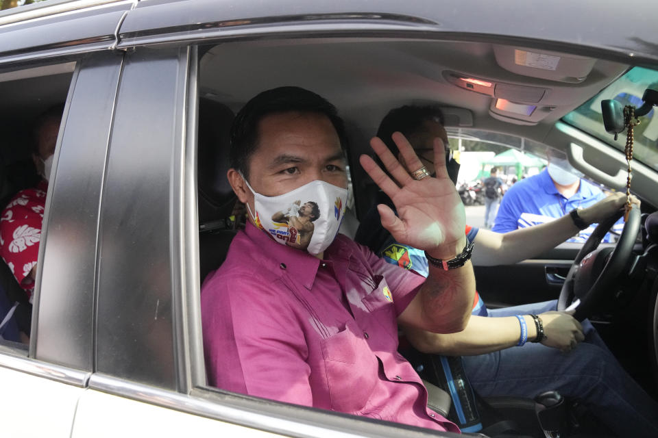 Retired Filipino boxing hero and senator Manny Pacquiao waves from his vehicle before filing his certificate of candidacy for next year's presidential elections at the Commission on Elections on Friday, Oct. 1, 2021 in Manila, Philippines. Friday marks the start of a weeklong registration period for candidates seeking to lead a Southeast Asian nation that has been hit hard by the pandemic and deep political conflicts.(AP Photo/Aaron Favila)