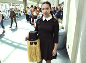 <p>Amanda Mossbarger, from San Diego, dressed as Wednesday Addams while carrying Cousin It from <em>The Addams Family</em> at Comic-Con International on July 19, 2018, in San Diego. (Photo: Richard Vogel/AP) </p>