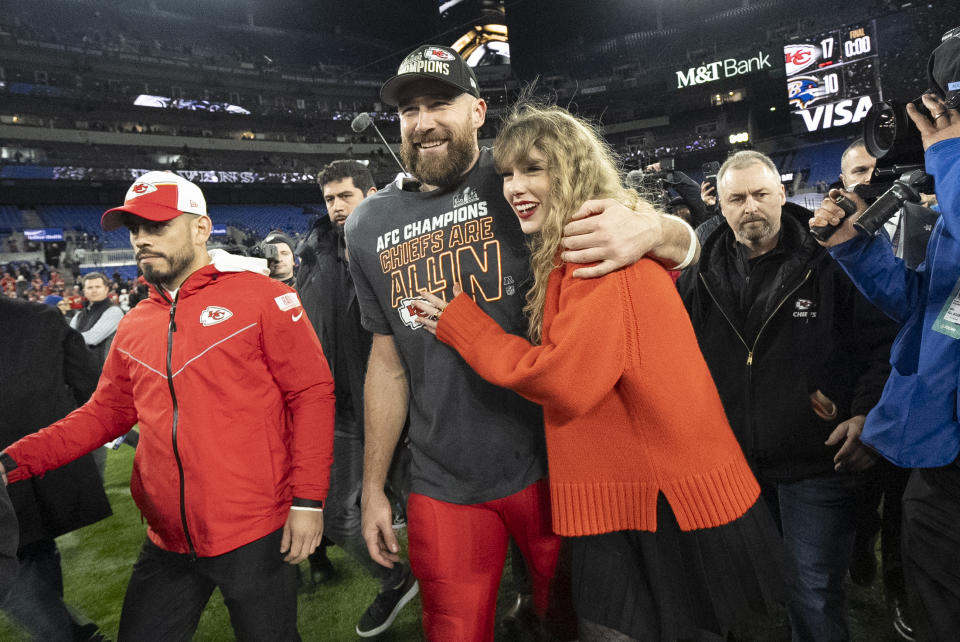 FILE - Kansas City Chiefs tight end Travis Kelce and Taylor Swift walk together after an AFC Championship NFL football game between the Chiefs and the Baltimore Ravens, Jan. 28, 2024, in Baltimore.. Taylor Swift, who is holding concerts in Japan, will make it in time for the Super Bowl to see her partner and football superstar Travis Kelce play. (AP Photo/Julio Cortez, File)