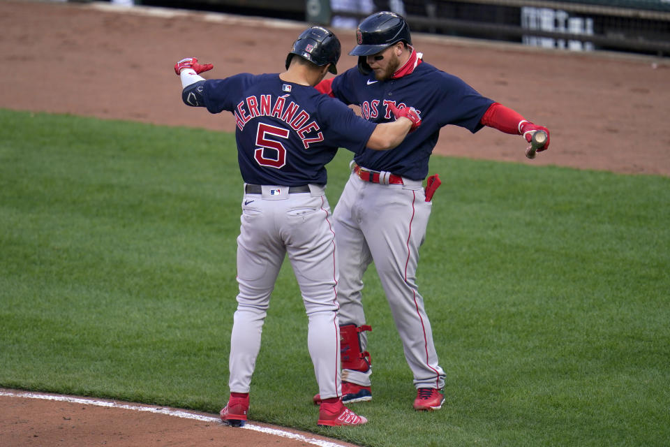 Boston Red Sox's Enrique Hernandez (5) celebrates his solo home run against the Baltimore Orioles with Alex Verdugo during the eighth inning of a baseball game, Thursday, April 8, 2021, on Opening Day in Baltimore. The Red Sox won 7-3. (AP Photo/Julio Cortez)