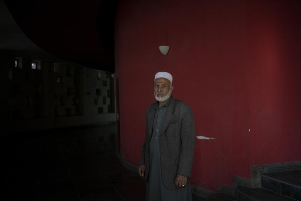 Rahmat Shah, who works as a host, poses for a photograph inside the Ariana Cinema in Kabul, Afghanistan on Thursday, Nov. 4, 2021. (AP Photo/Bram Janssen)
