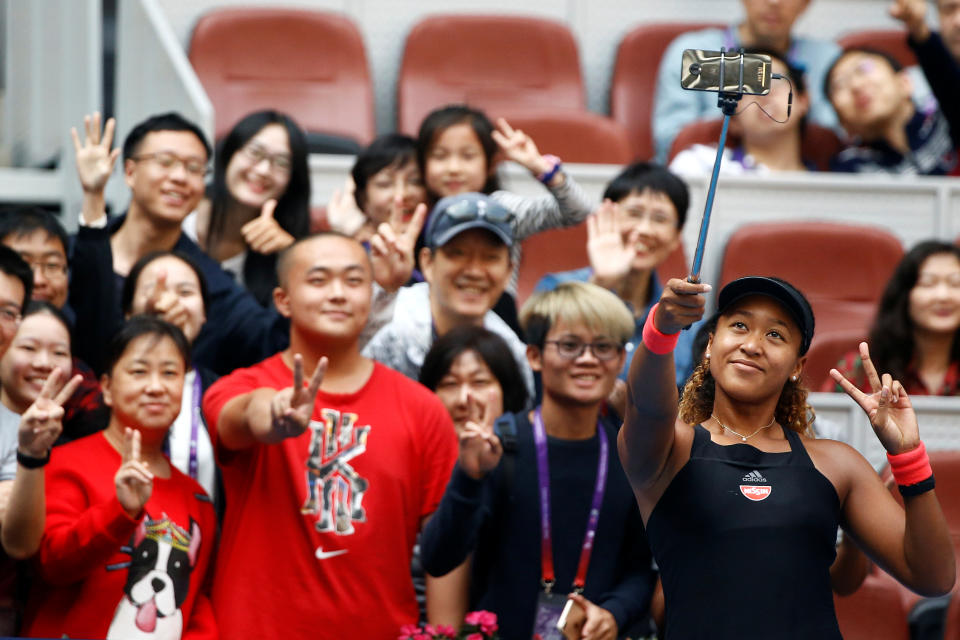 Tennis - China Open - Women's Singles - Third Round - National Tennis Center, Beijing, China - October 4, 2018.  Naomi Osaka of Japan takes a selfie with fans after her match against Julia Goerges of Germany.  REUTERS/Thomas Peter