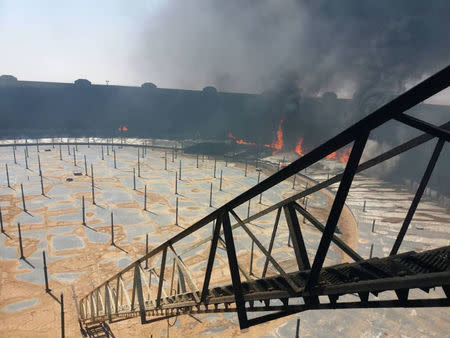 Smoke and flame rise from an oil storage tank that was set on fire amid fighting between rival factions at Ras Lanuf terminal, Libya in this handout picture released on June 16, 2018. The National Oil Corporation/ Handout via Reuters