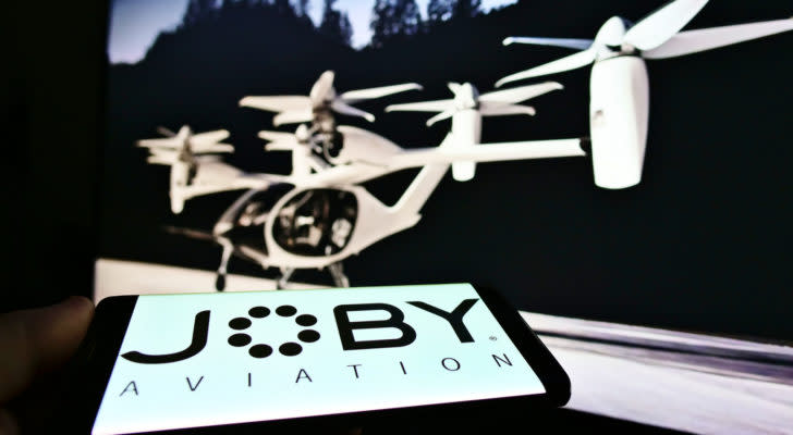 Person holding smartphone with logo of startup and aerospace company Joby Aviation (air taxi) on screen
