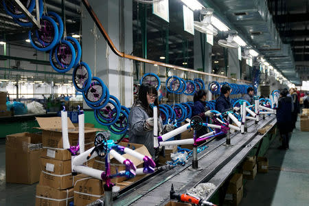 Employees work on the production line of Kent bicycles at Shanghai General Sports Co., Ltd, in Kunshan, Jiangsu Province, China, February 22, 2019. Picture taken February 22, 2019. REUTERS/Aly Song