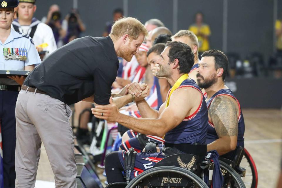 <p>Chris Jackson/Getty Images for the Invictus Games Foundation</p> Prince Harry congratulates a member of the U.S. wheelchair basketball team after their gold medal win at the 2018 Invictus Games in Sydney.