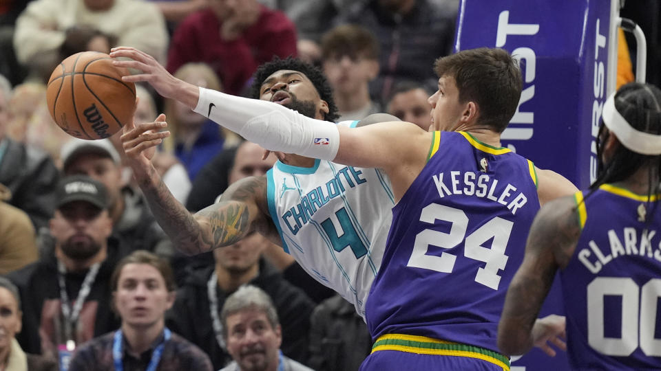 Utah Jazz center Walker Kessler (24) fouls Charlotte Hornets center Nick Richards (4) during the first half of an NBA basketball game Thursday, Feb. 22, 2024, in Salt Lake City. (AP Photo/Rick Bowmer)