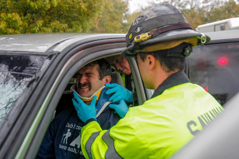 Savannah firefighters place a cervical collar on a patient while participating in a drill on Friday March 10, 2023.