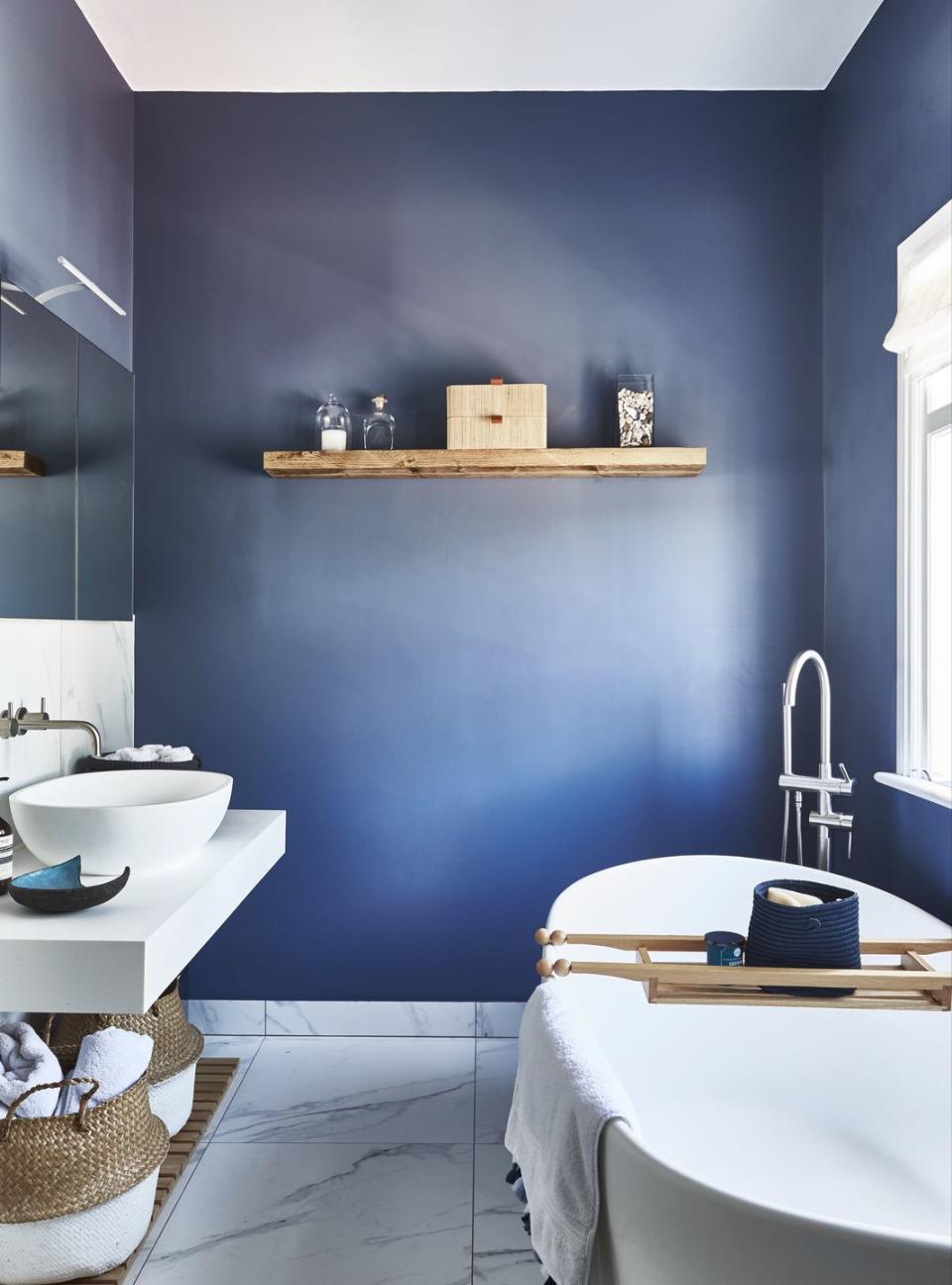 a bathroom with a tub sink and a shelf with objects on it