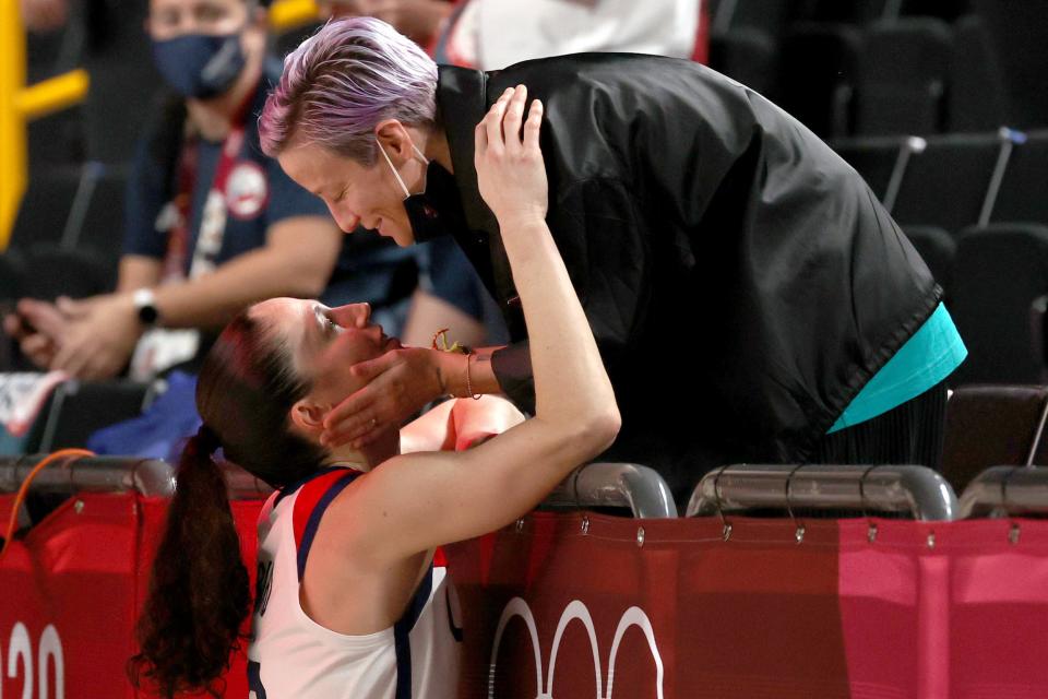 Megan Rapinoe kisses Sue Bird following the latter's gold-medal win in Tokyo.