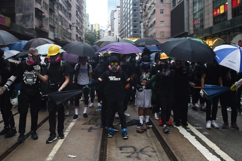 Protesters block a road during clashes with police in the Wanchai district in Hong Kong on October 6, 2019. | MOHD RASFAN—AFP via Getty Images