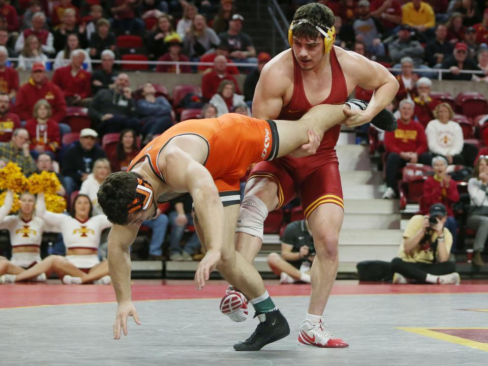 Iowa State Cyclones Sam Schuyler takes down Oklahoma State Cowboys Kyle Hass during their 285-pound wrestling in a dual meet at Hilton Coliseum Sunday, Jan. 29, 2023, in Ames, Iowa.