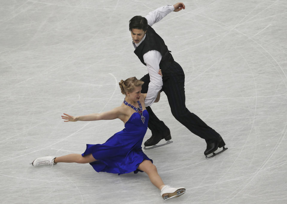 Kaitlyn Weaver and Andrew Poje of Canada perform during the ice dance short dance event of the World Figure Skating Championships in Saitama, near Tokyo, Friday, March 28, 2014. (AP Photo/Koji Sasahara)