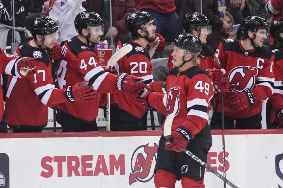 New Jersey Devils' Fabian Zetterlund (49) is congratulated for his goal against the Winnipeg Jets during the third period of an NHL hockey game Sunday, Feb. 19, 2023, in Newark, N.J. The Devils won 4-2. (AP Photo/Frank Franklin II)